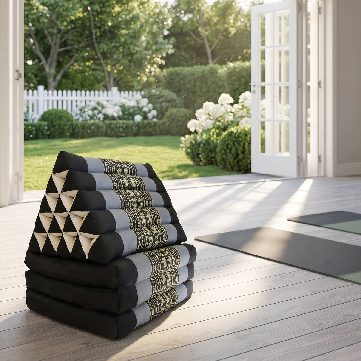 Blue Elephant Jumbo 3-fold Thai triangle floor mattress, folded, in a garden yoga studio