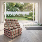 Mix Elephant Jumbo 3-fold Thai triangle floor mattress, folded, in a garden yoga studio