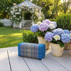 Blue yoga block beside hydrangeas on a garden deck