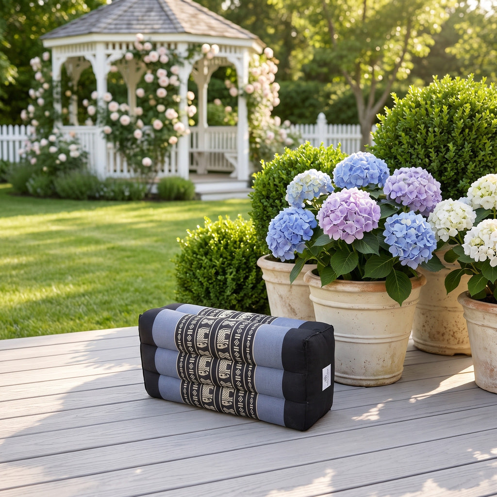 Blue elephant pattern yoga block beside hydrangeas on a garden deck