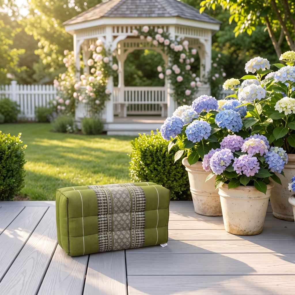 Green yoga block beside hydrangeas on a garden deck