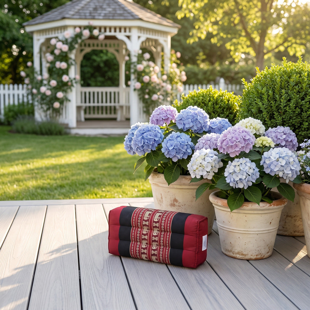Red elephant pattern yoga block beside hydrangeas on a garden deck