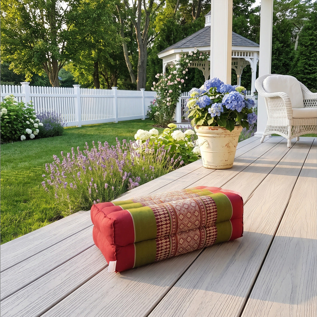 Red and green yoga block on a sunlit garden deck
