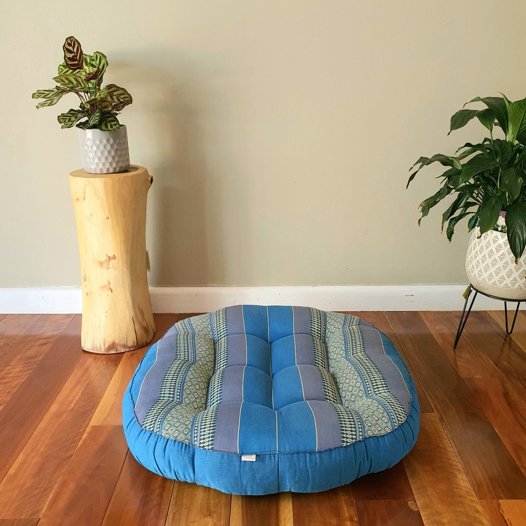 Blue jumbo round Thai kapok meditation cushion in a styled room