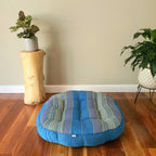Blue jumbo round Thai kapok meditation cushion in a styled room