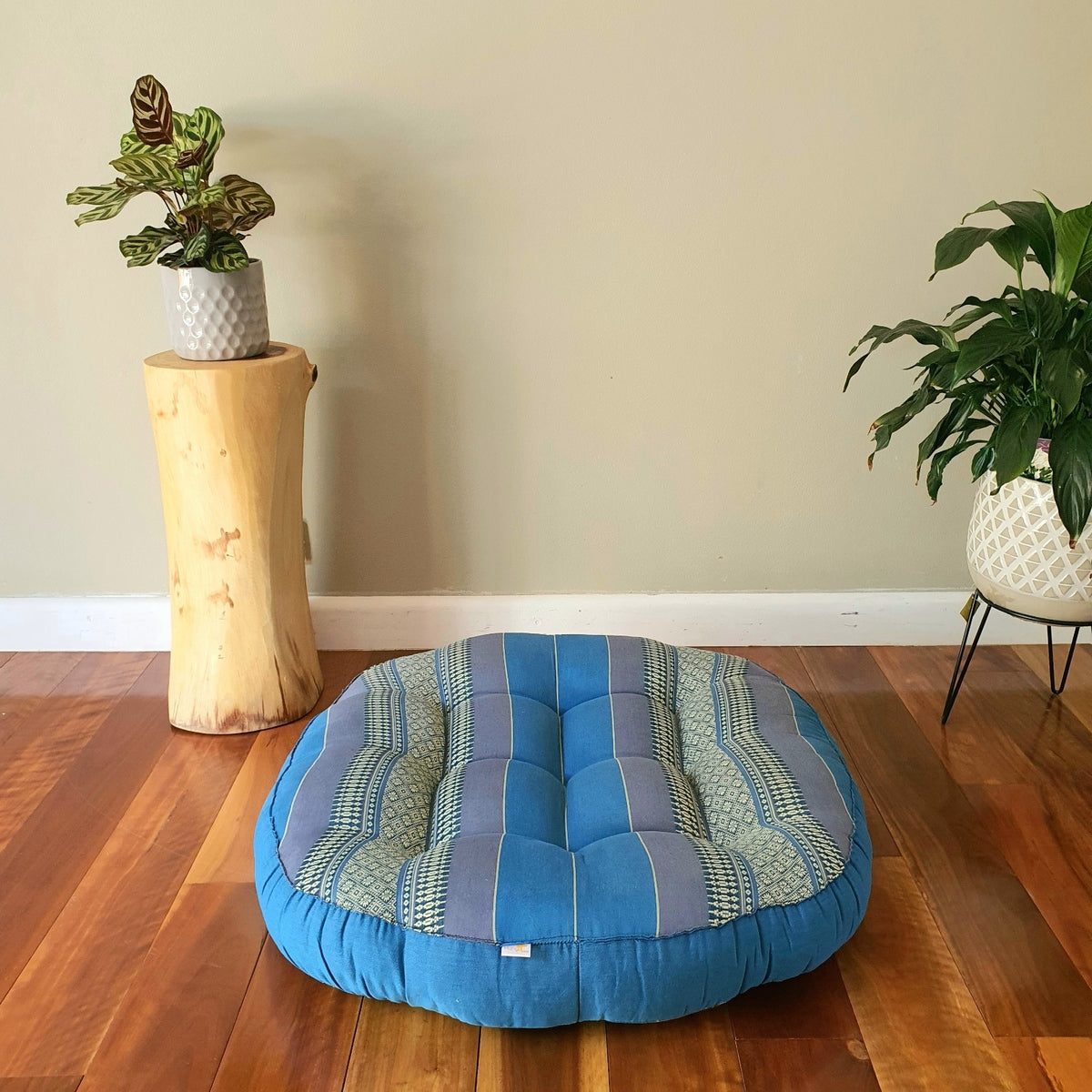 Blue jumbo round Thai kapok meditation cushion in a styled room